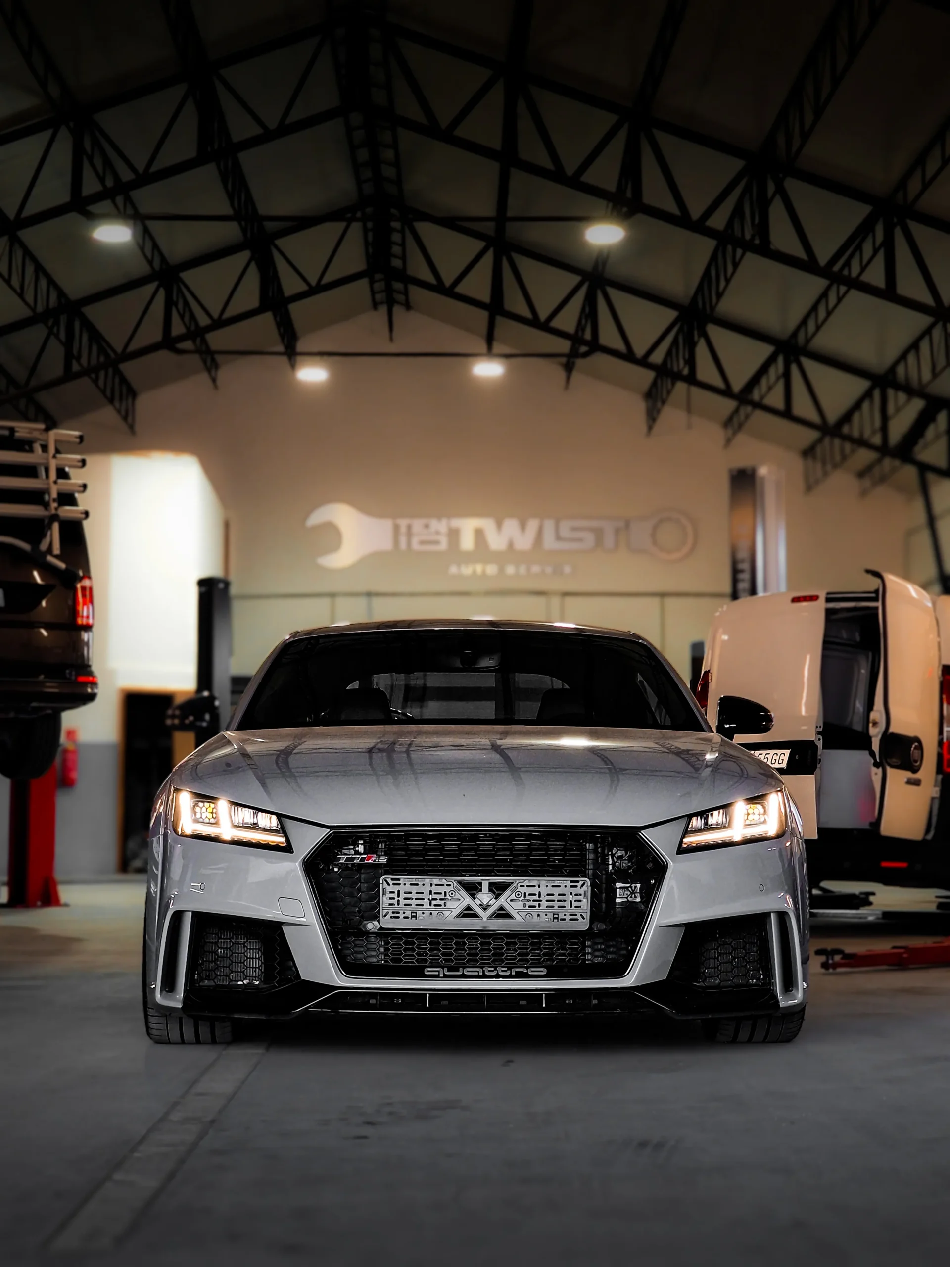 Silver sports car in the workshop