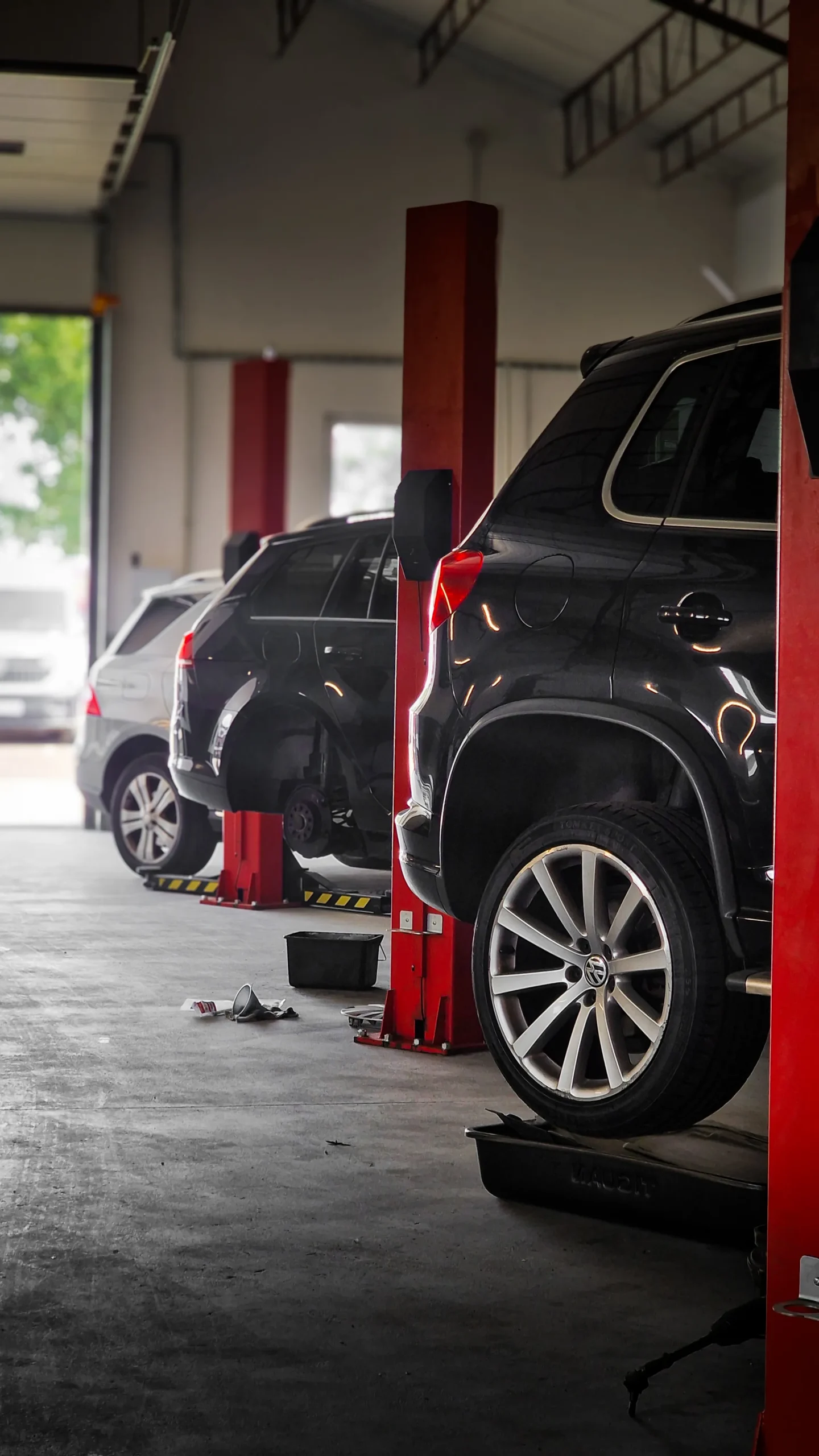 Row of cars beside workshop lifts