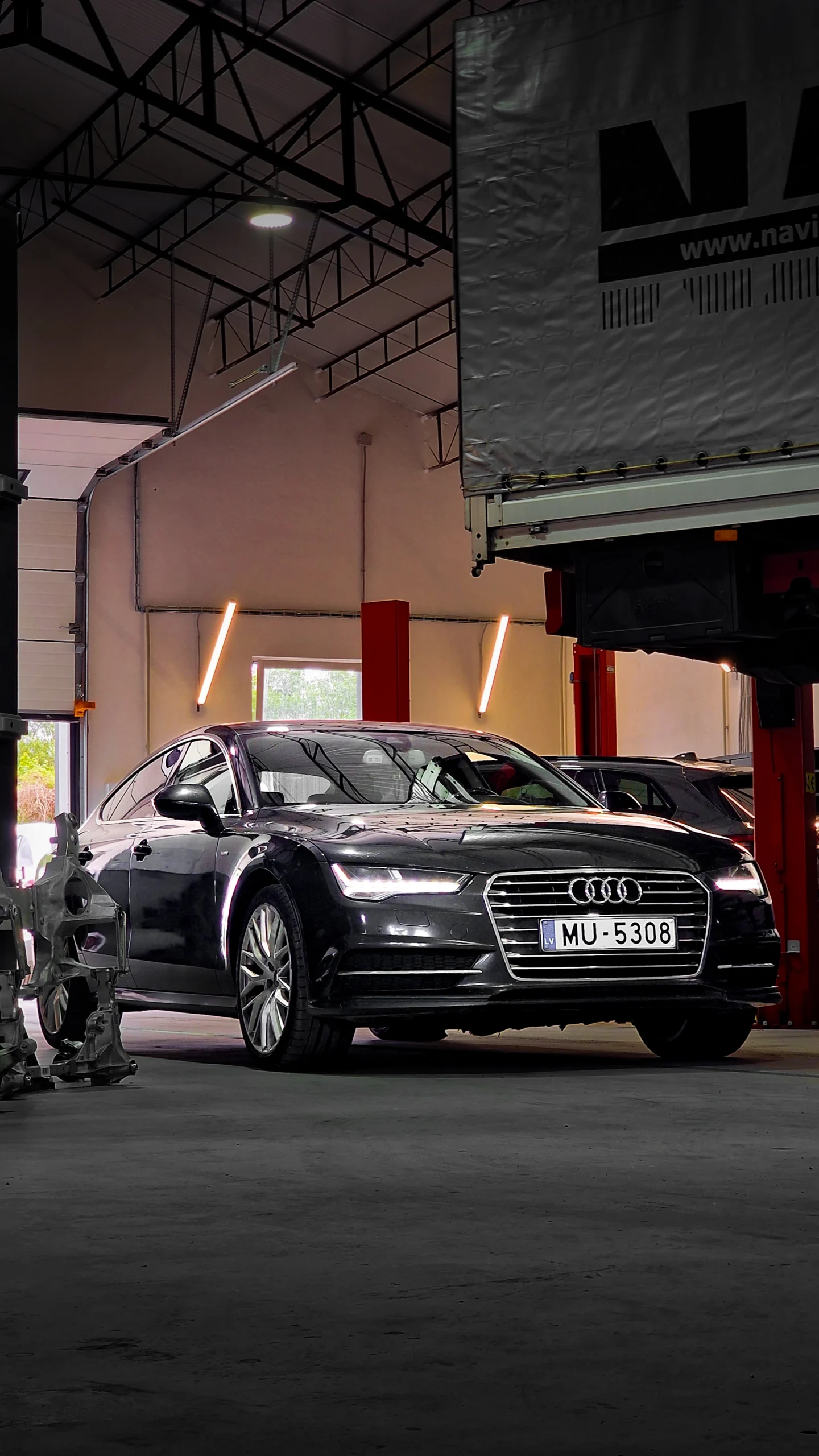 Dark luxury Audi entering the workshop