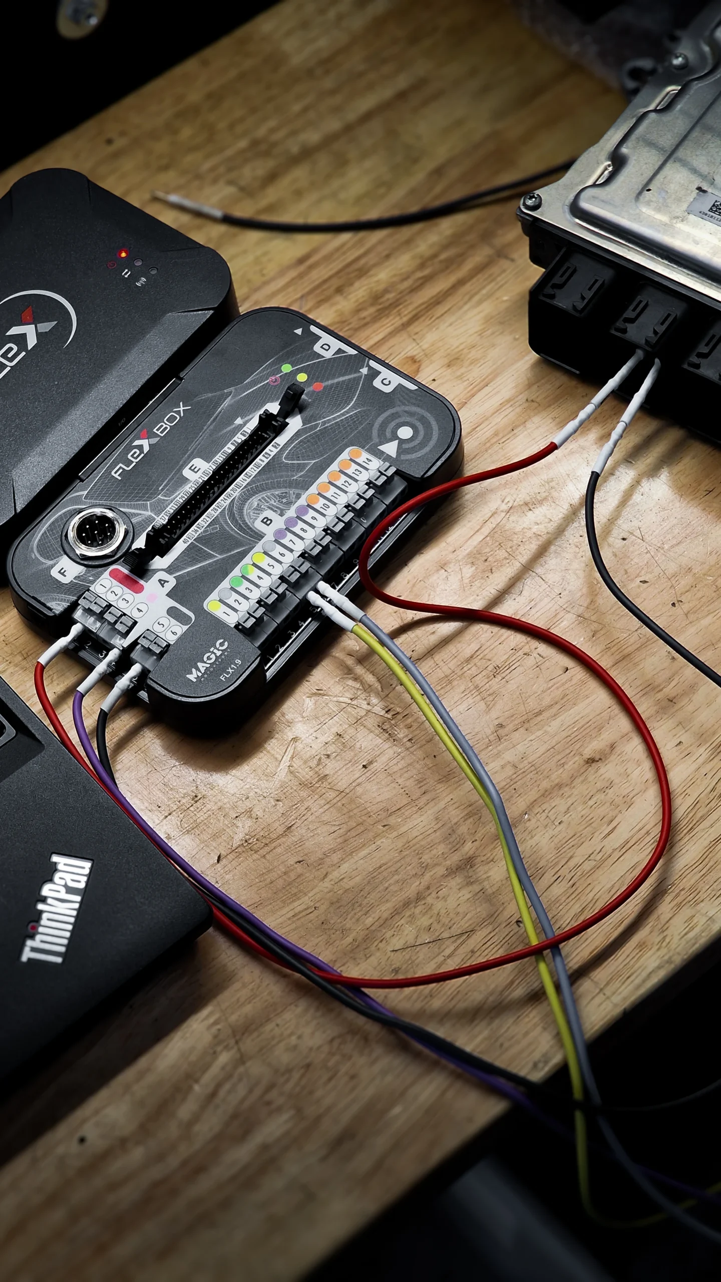 Control unit connected by cables to equipment on a workbench