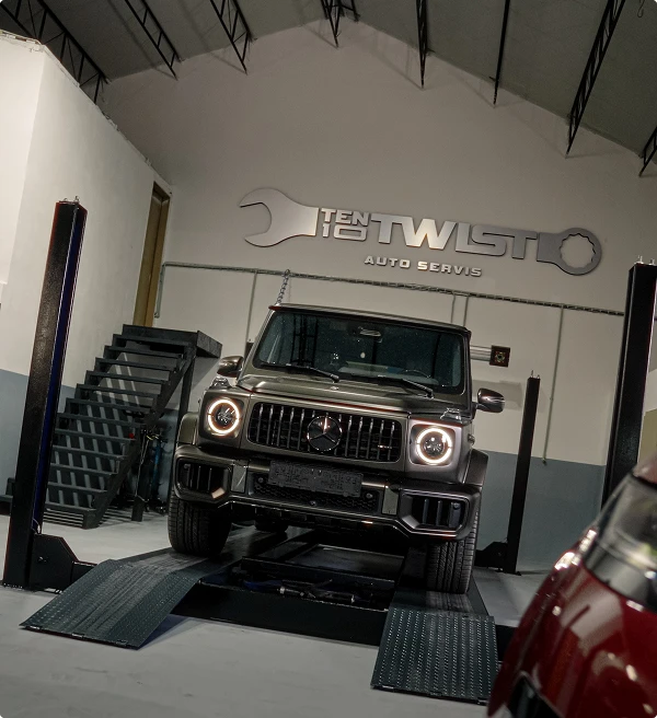 Dark SUV on a workshop platform
